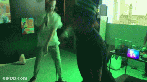 A Man Wearing A Virtual Reality Headset Is Dancing In A Room GIF