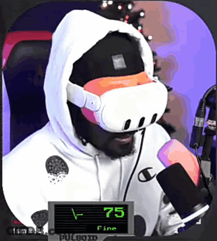 A Man Wearing A Virtual Reality Headset Is Sitting In Front Of A Microphone And A Sign That Says 75 Fine GIF