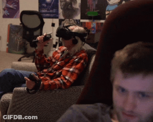 Man Wearing VR Headset Sitting On Chair GIF