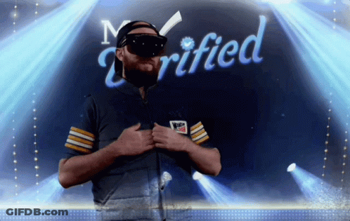 A Man Wearing A Virtual Reality Headset Is Standing In Front Of A Sign That Says Verified GIF