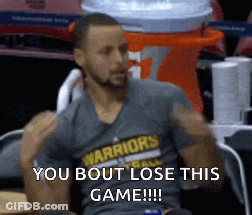 A Man Wearing A Warriors Shirt Is Sitting In A Chair With His Arms In The Air . GIF