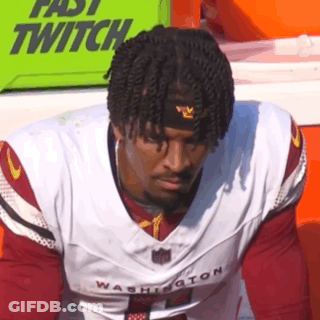A Man Wearing A Washington Football Jersey And A Headband . GIF