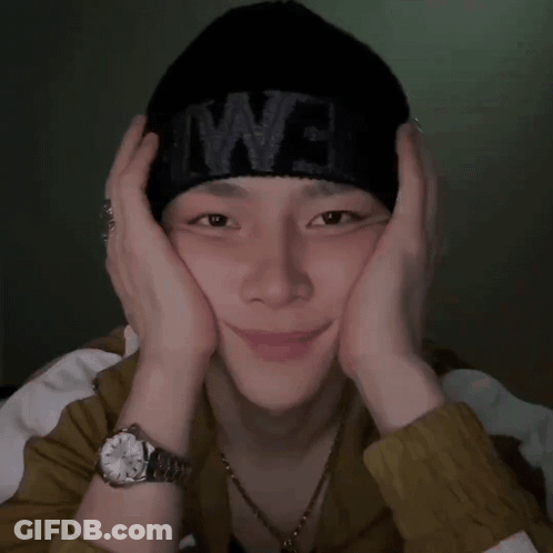 A Man Wearing A Watch And A Black Beanie With The Word We On It GIF