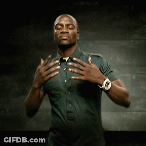 A Man Wearing A Watch Holds His Hands Over His Chest GIF