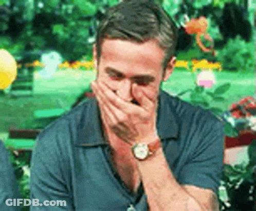 A Man Wearing A Watch Is Covering His Mouth With His Hands . GIF