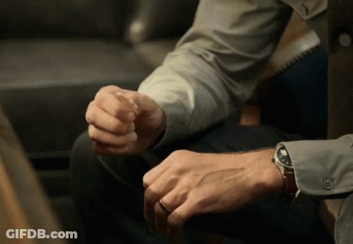 A Man Wearing A Watch Is Sitting Down GIF
