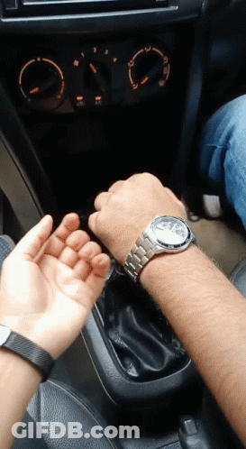 A Man Wearing A Watch Is Sitting In A Car With A Woman GIF