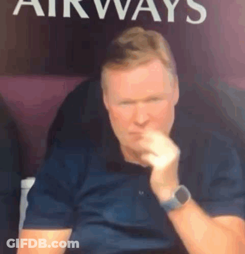 A Man Wearing A Watch Is Sitting In Front Of A Sign That Says `` Airways '' . GIF