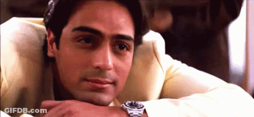 A Man Wearing A Watch Rests His Head On His Hand . GIF