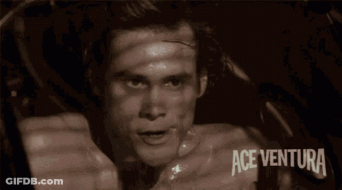 A Man Wearing A Watch With Ace Ventura Written On The Bottom Right GIF