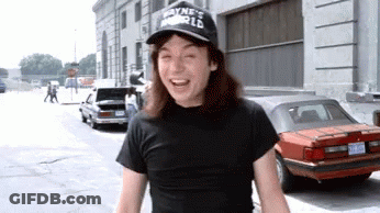 A Man Wearing A Wayne 'S World Hat Is Laughing GIF