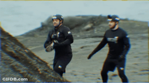A Man Wearing A Wet Suit With The Word Scuba On It GIF