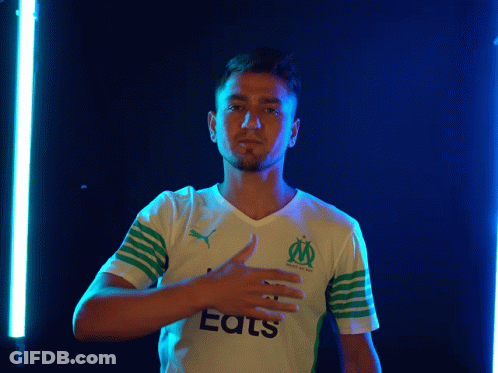A Man Wearing A White And Green Shirt That Says Eats GIF