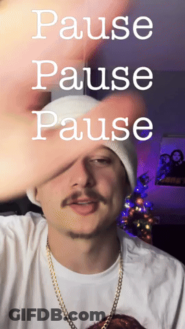 A Man Wearing A White Beanie And A Gold Chain Says Pause GIF