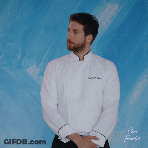 A Man Wearing A White Chef 'S Jacket With The Name Iskender Topuz GIF