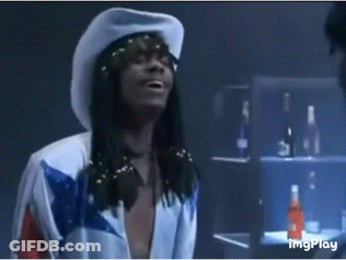 A Man Wearing A White Cowboy Hat And A Blue And White Shirt GIF