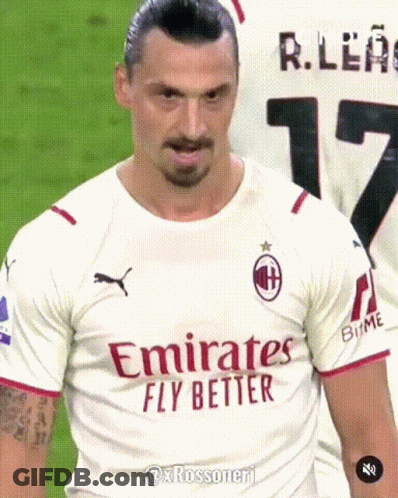 A Man Wearing A White Emirates Fly Better Shirt GIF