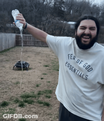 A Man Wearing A White Fear Of God Essentials Shirt GIF