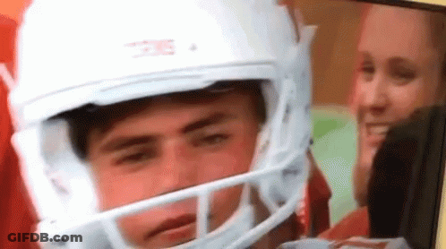 A Man Wearing A White Football Helmet With The Word Texas On It . GIF