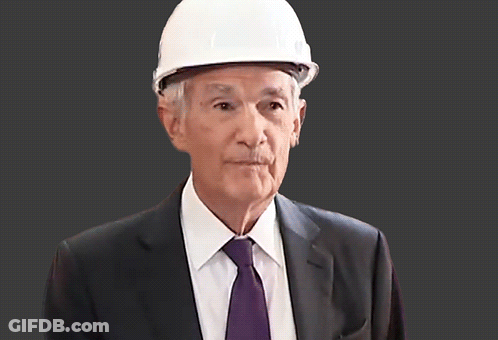 A Man Wearing A White Hard Hat And A Suit GIF