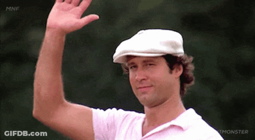A Man Wearing A White Hat And A Pink Shirt Waves GIF
