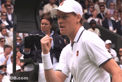 A Man Wearing A White Hat And A White Shirt Holds His Fist Up GIF