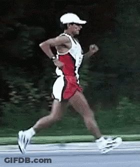 A Man Wearing A White Hat And Shorts Is Running GIF