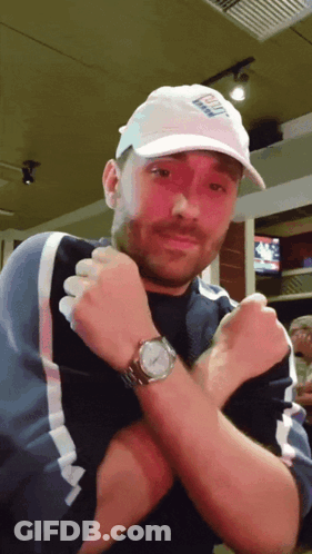 A Man Wearing A White Hat That Says ' Bud Light ' On It GIF