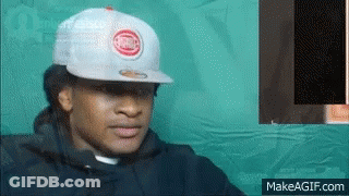 A Man Wearing A White Hat With A Chicago Cubs Logo On It . GIF