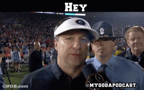 A Man Wearing A White Hat With The Letter G On It Talks Into A Microphone GIF