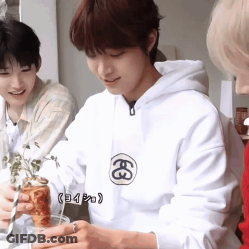 A Man Wearing A White Hoodie With The Letter E On The Front GIF