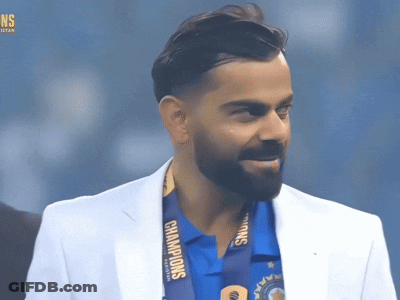 A Man Wearing A White Jacket And A Medal That Says Champions On It GIF