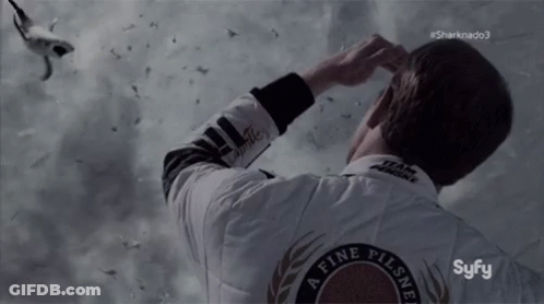 A Man Wearing A White Jacket That Says ' A Fine Pilsner ' On The Back GIF
