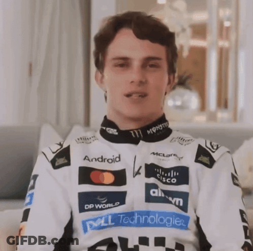 A Man Wearing A White Jacket With Logos For Dell Technologies And Monster Energy On It GIF