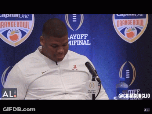 A Man Wearing A White Jacket With The Letters A On It GIF