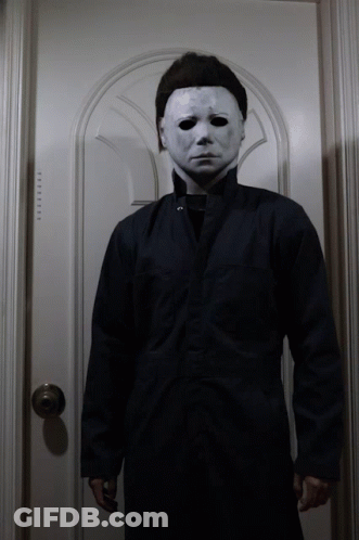 A Man Wearing A White Mask And A Black Jacket GIF