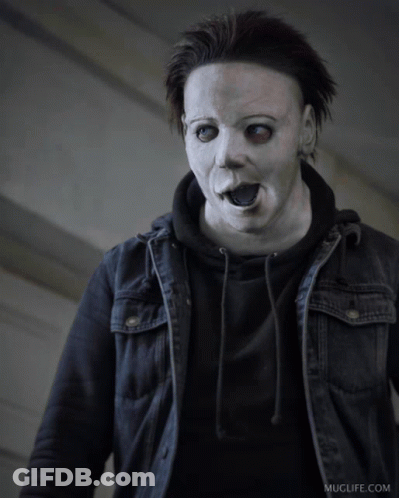 A Man Wearing A White Mask And A Black Jacket Has Muglife.com Written On The Bottom Right GIF