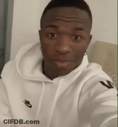 A Man Wearing A White Nike Hoodie Is Looking At The Camera GIF