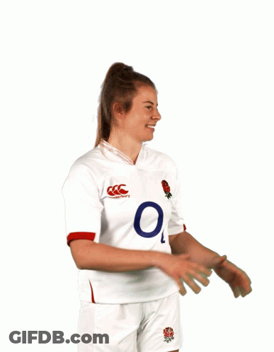 A Man Wearing A White O2 Jersey Holds A Rugby Ball In Front Of His Face GIF