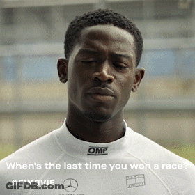 A Man Wearing A White Omp Shirt Is Looking Down GIF