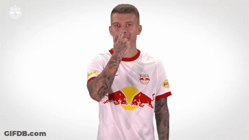 A Man Wearing A White Red Bull Jersey Making A Funny Face GIF