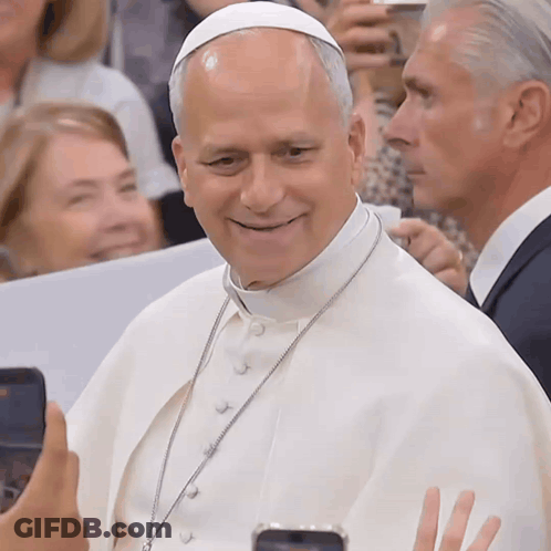 A Man Wearing A White Robe And A White Hat Is Smiling GIF