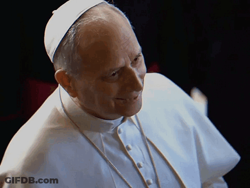 A Man Wearing A White Robe And A White Hat Is Smiling GIF