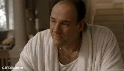 A Man Wearing A White Robe And A White Shirt Is Smiling . GIF