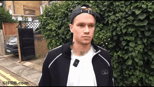 A Man Wearing A White Shirt And A Black Jacket Has A Tattoo On His Neck That Says " I Love You " GIF