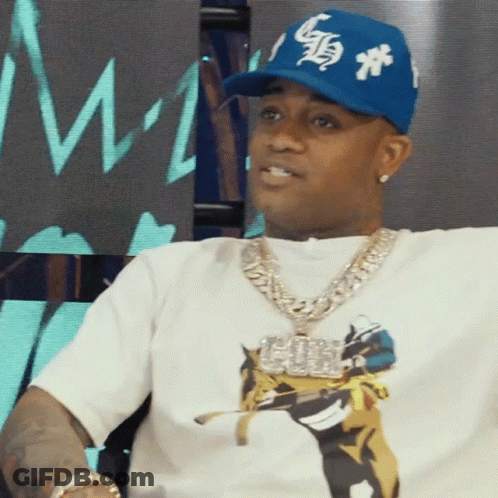 A Man Wearing A White Shirt And A Blue Hat With The Letter S On It GIF