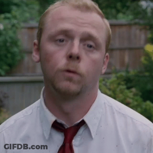 A Man Wearing A White Shirt And A Red Tie Looks At The Camera GIF