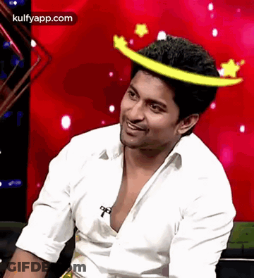 A Man Wearing A White Shirt And A Yellow Crown On His Head . GIF