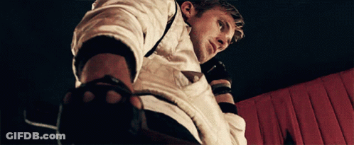 A Man Wearing A White Shirt And Black Gloves Looks Down GIF