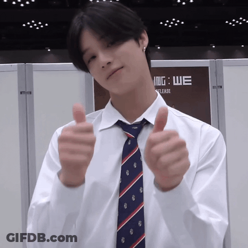 A Man Wearing A White Shirt And Tie Gives A Thumbs Up GIF